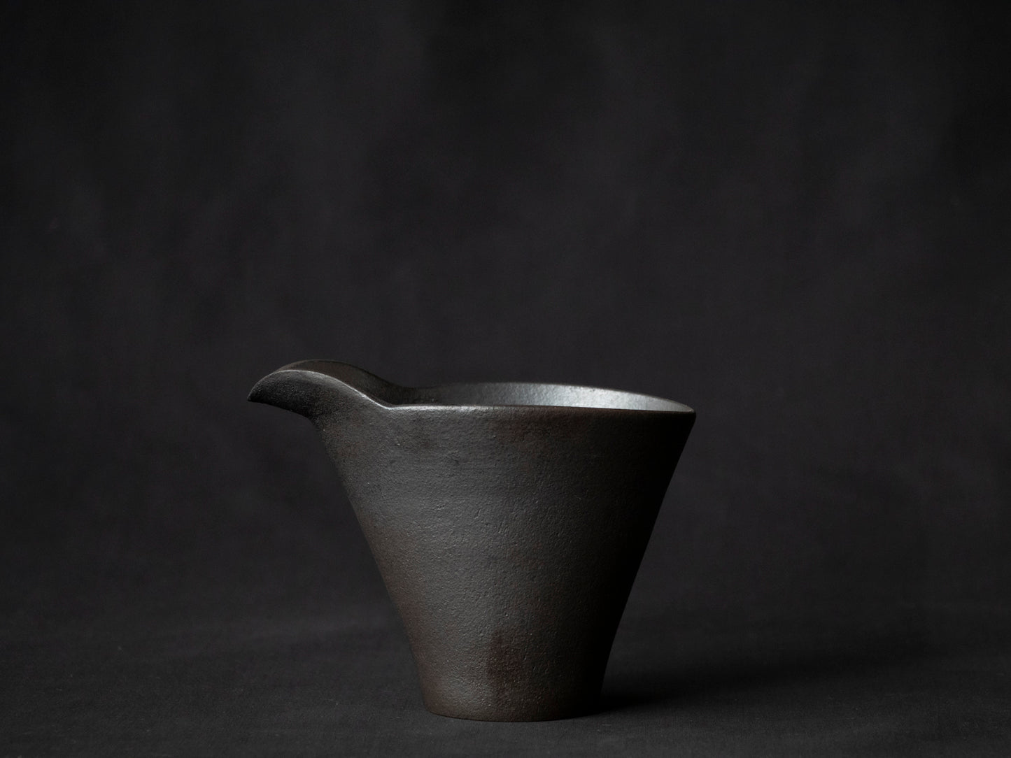 side view of black ceramic carafe