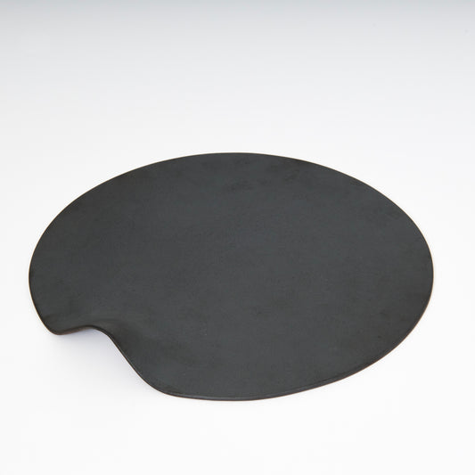 Black round ceramic plate with one built in handle